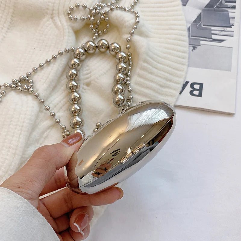 Minaudière metálica mini con cadena cruzada