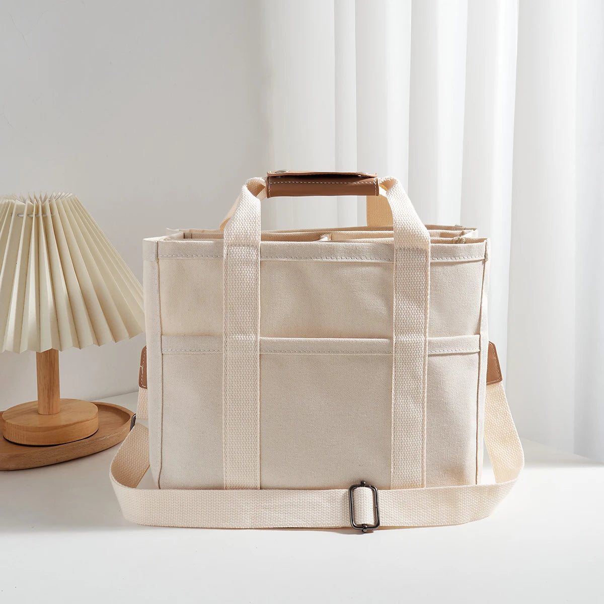 Bolso tote de lona con múltiples bolsillos y correa regulable