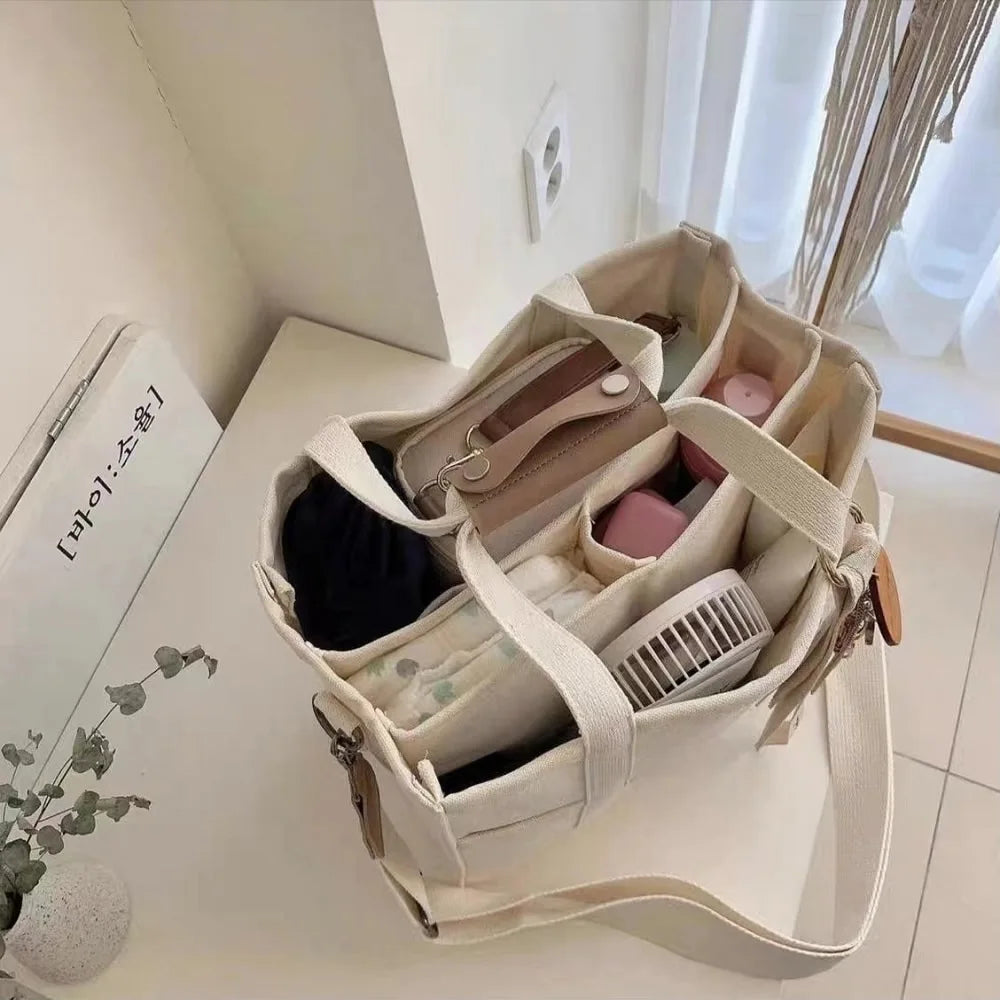 Bolso tote de lona con múltiples bolsillos y correa regulable