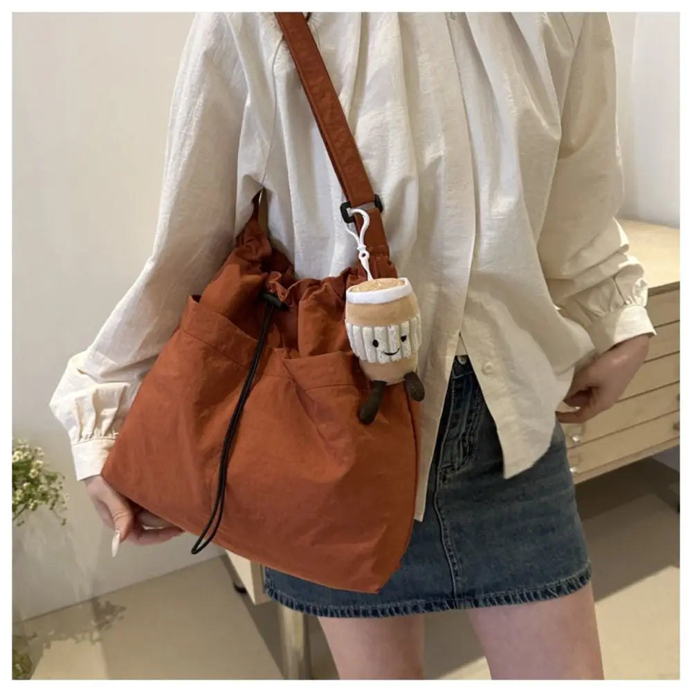 Cartera balde de nylon con cordón y dije opcional