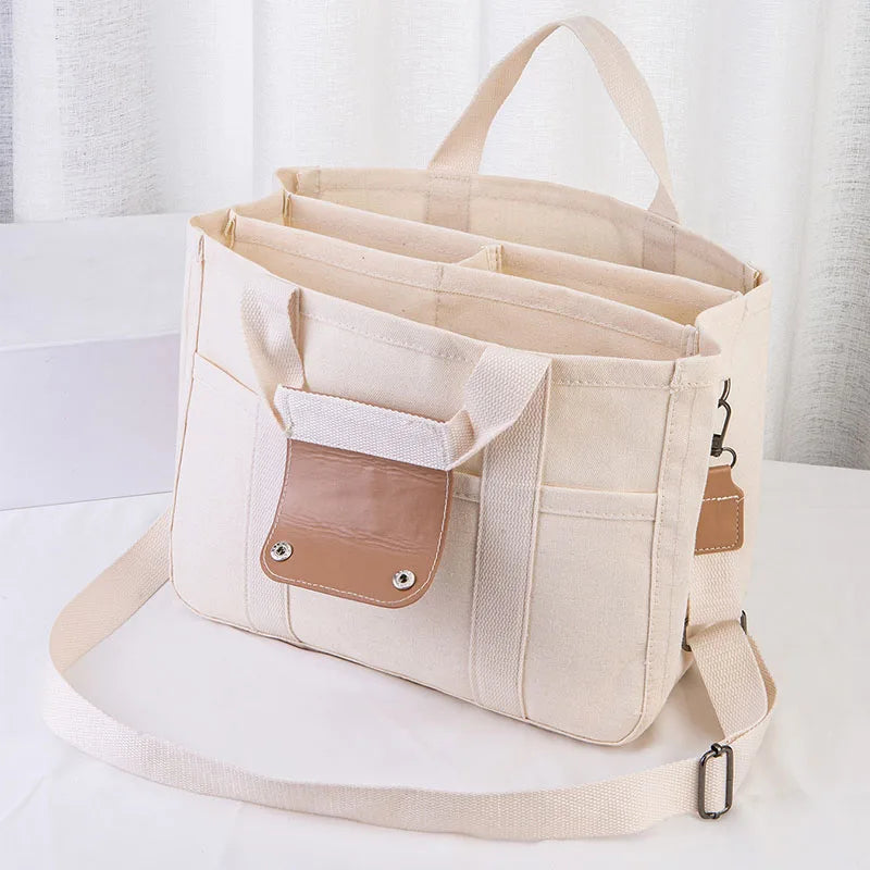 Bolso tote de lona con múltiples bolsillos y correa regulable