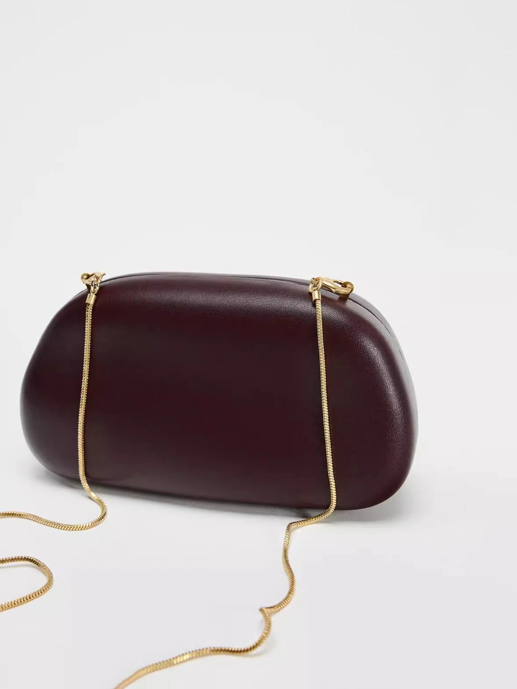 Clutch ovalado de fiesta con cadena y cierre metálico
